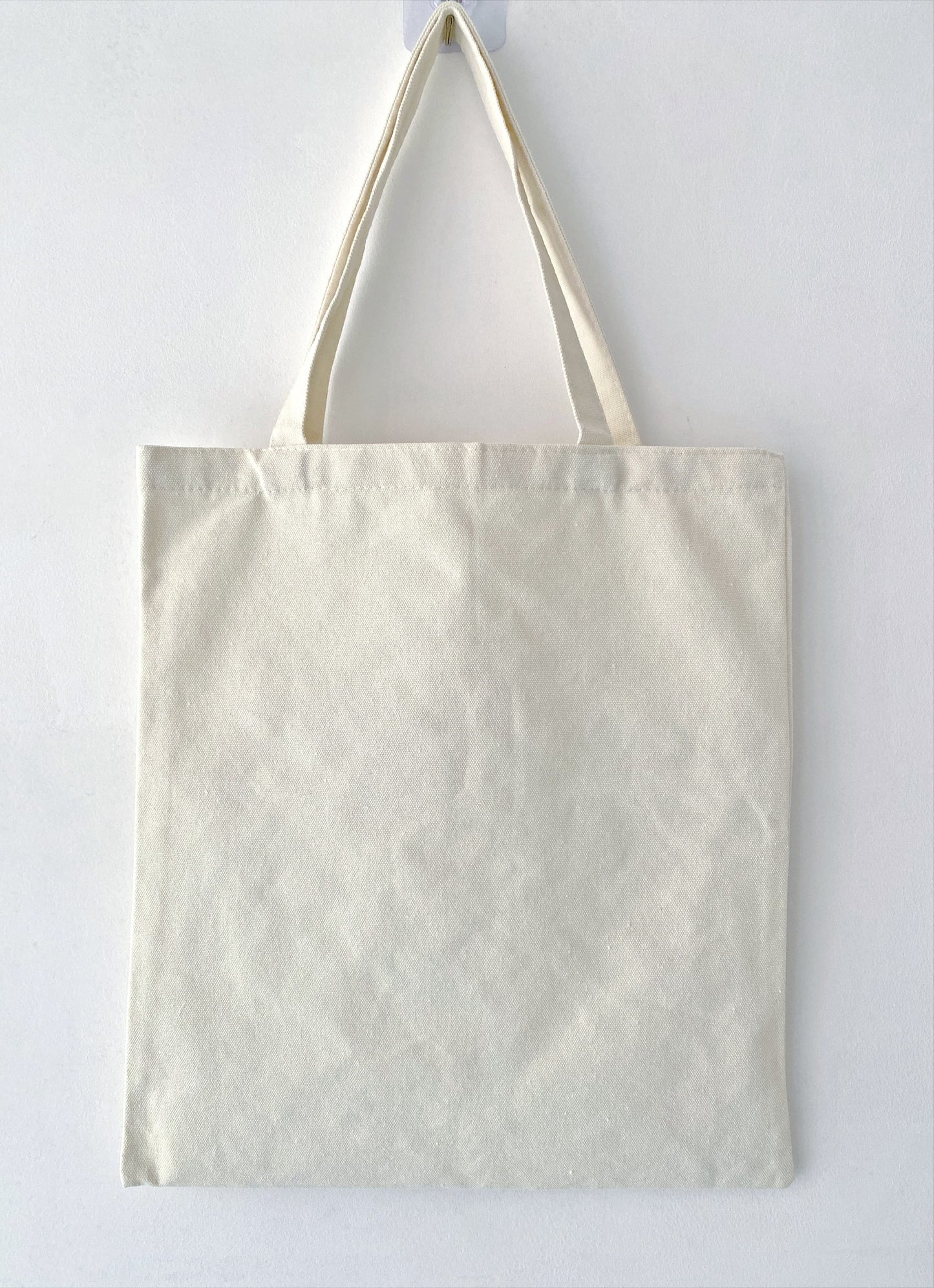 For the minimalist who still loves a pop of personality: a sturdy, eco-friendly tote that balances clean lines with the organic, imperfect beauty of hand-stitched art.