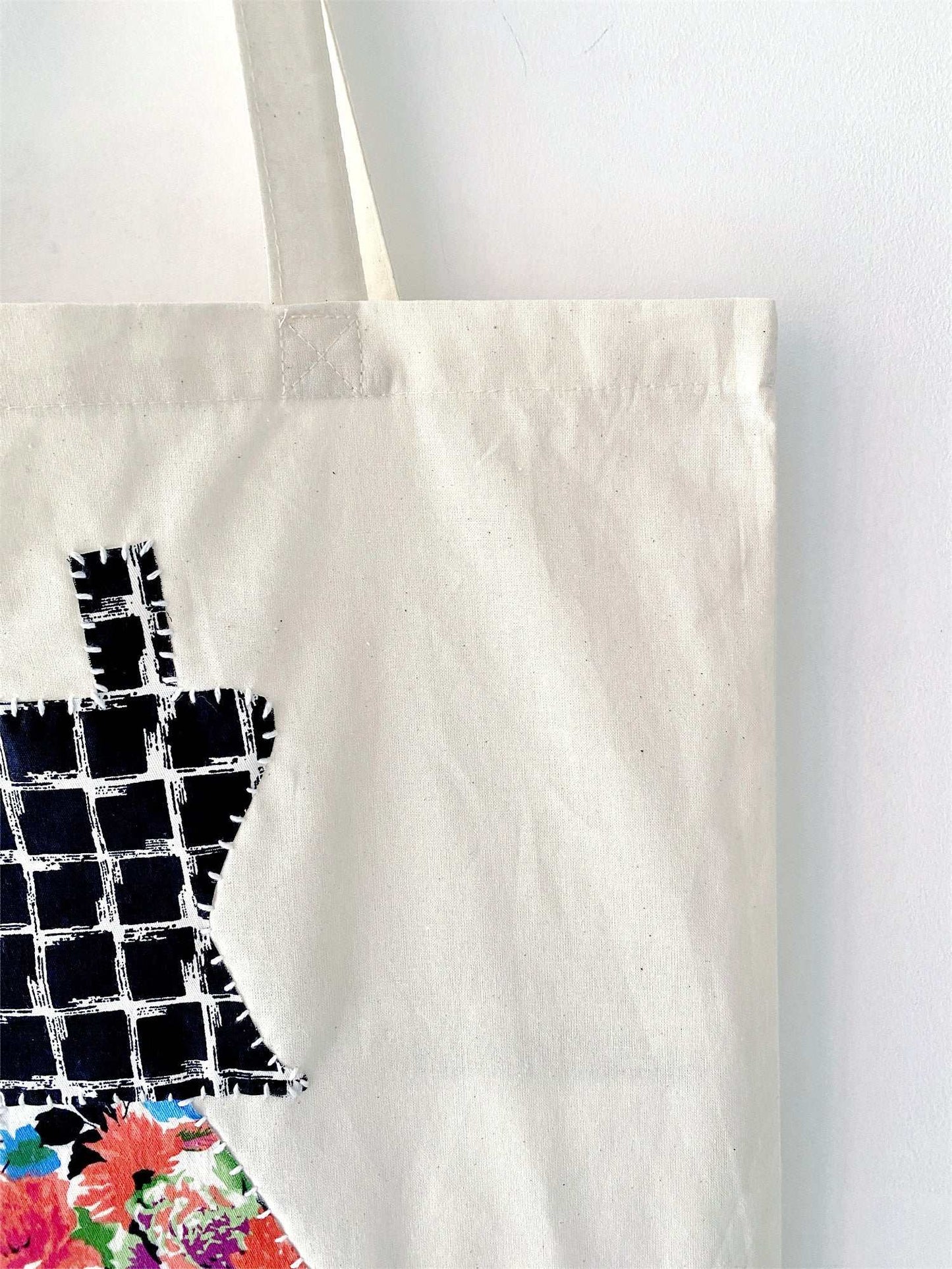 This patchwork tote is favored for errands and short trips, where lightness and emotional comfort matter more than bold branding