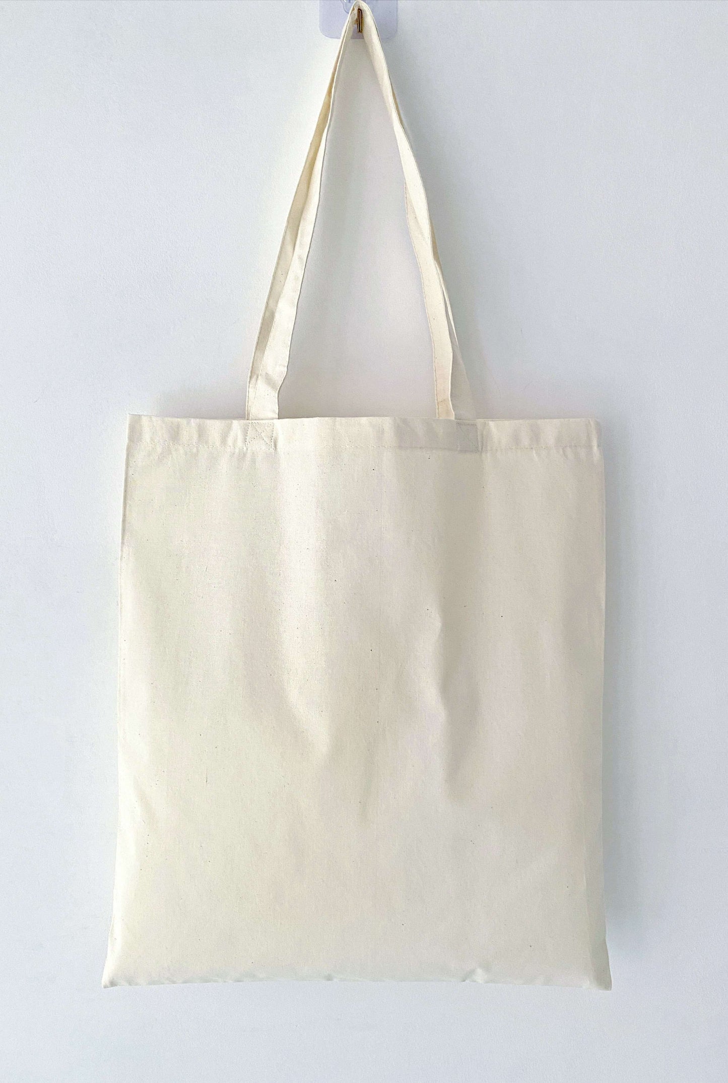 A cotton tote with a hand-printed kitty design, frequently gifted to someone who enjoys simple daily items with a personal touch.