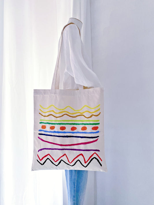 Large carryall bag fitting a 15-inch laptop and a rolled-up yoga mat.