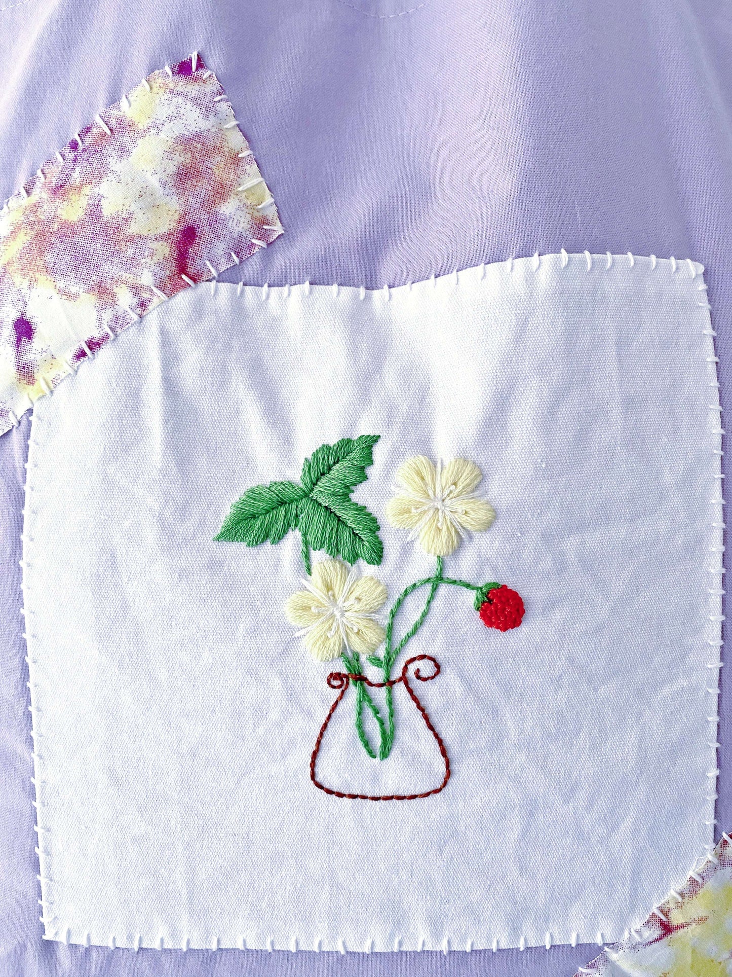 Artist's purple tote holding sketchbooks, featuring hand-stitched details that appeal to creative makers.