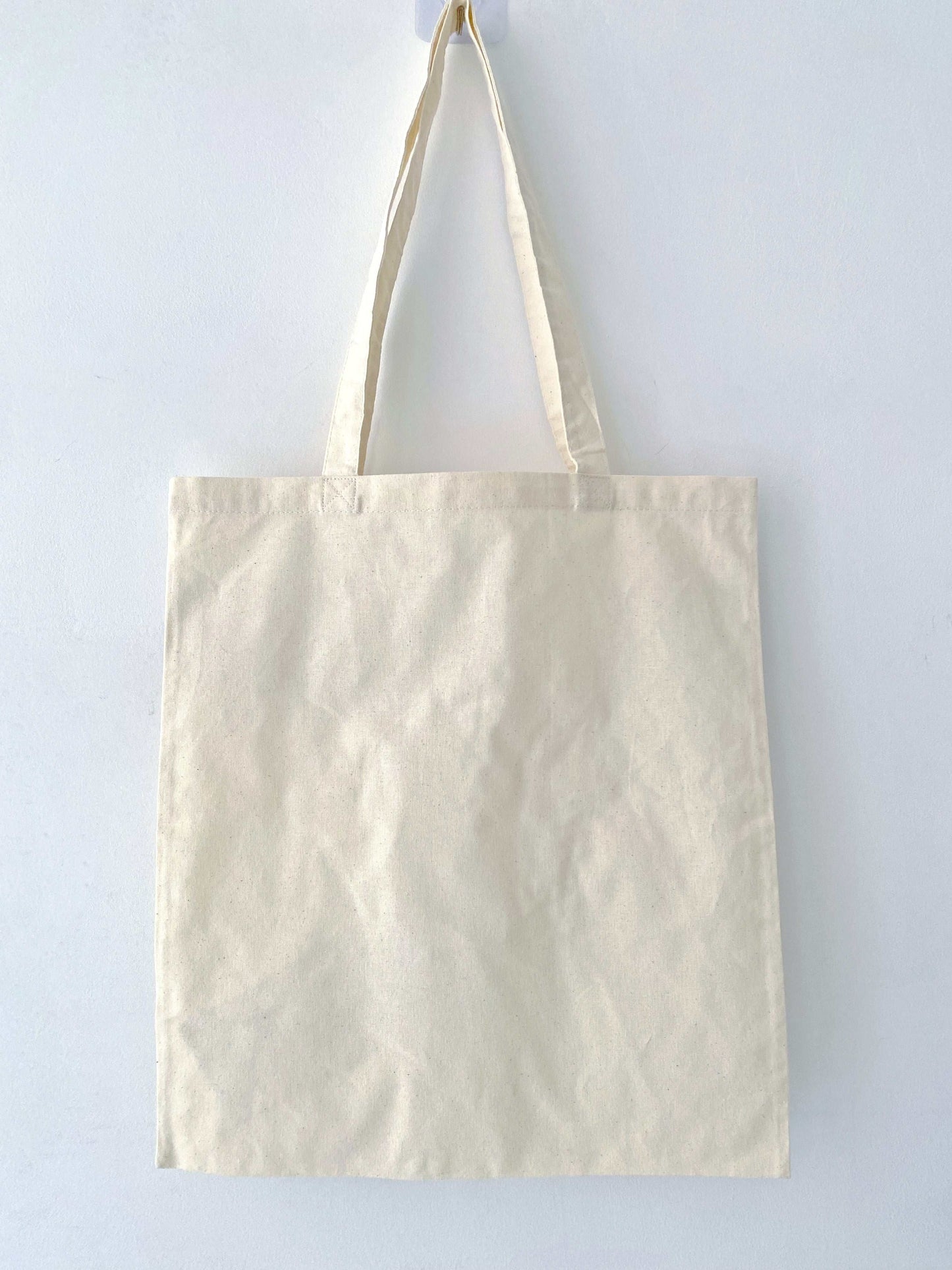 Sustainable cotton tote with stitched patchwork accents, frequently bought as a thoughtful birthday or holiday gift without feeling commercial