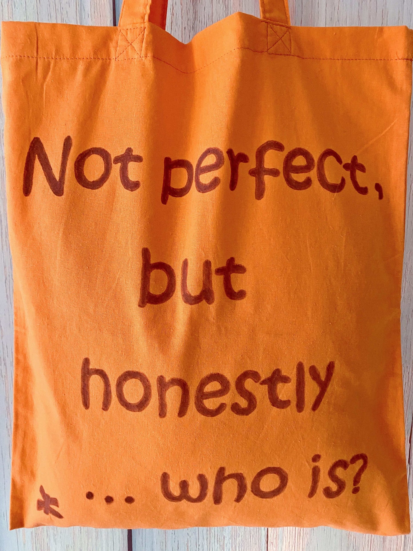 Lightweight travel carryall in burnt orange that folds tiny but fits a whole weekend outfit.