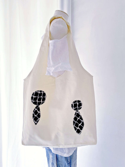 Textured patchwork bag adding warmth and character to a minimalist Scandinavian outfit.