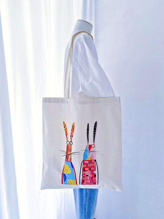 Sunlight filtering through a thin, airy cotton tote with a rabbit print, demonstrating the eco-friendly fabric's natural transparency and lightness.