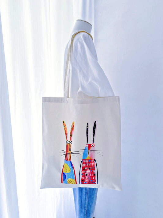 Sunlight filtering through a thin, airy cotton tote with a rabbit print, demonstrating the eco-friendly fabric's natural transparency and lightness.