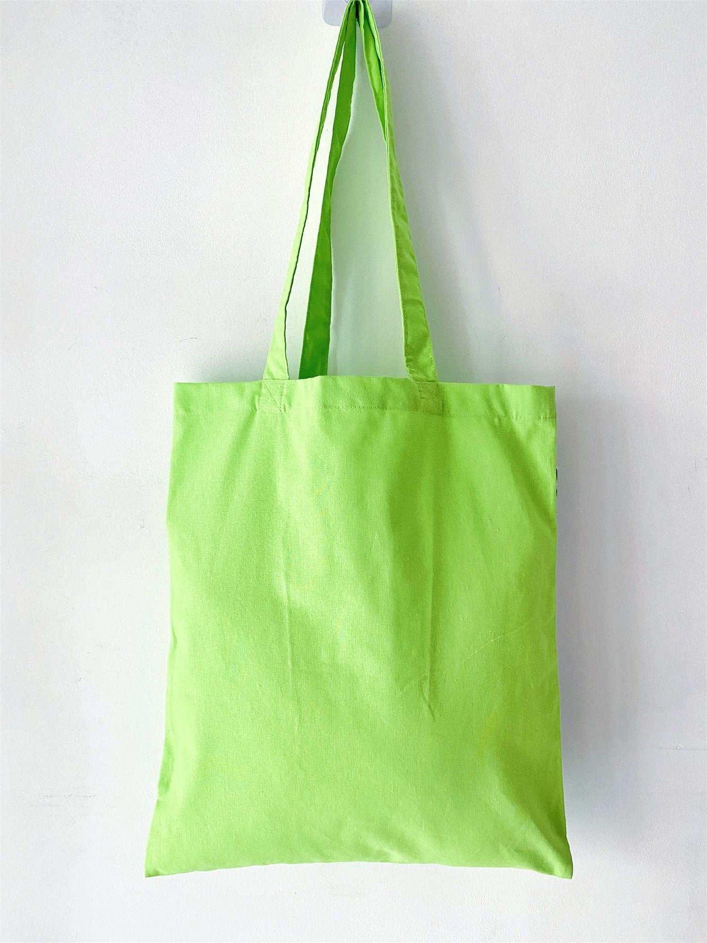 Thoughtfully designed with a hand-stitched patchwork pattern, this green cotton tote is a great gift idea for eco-friendly shoppers or as a daily accessory.
