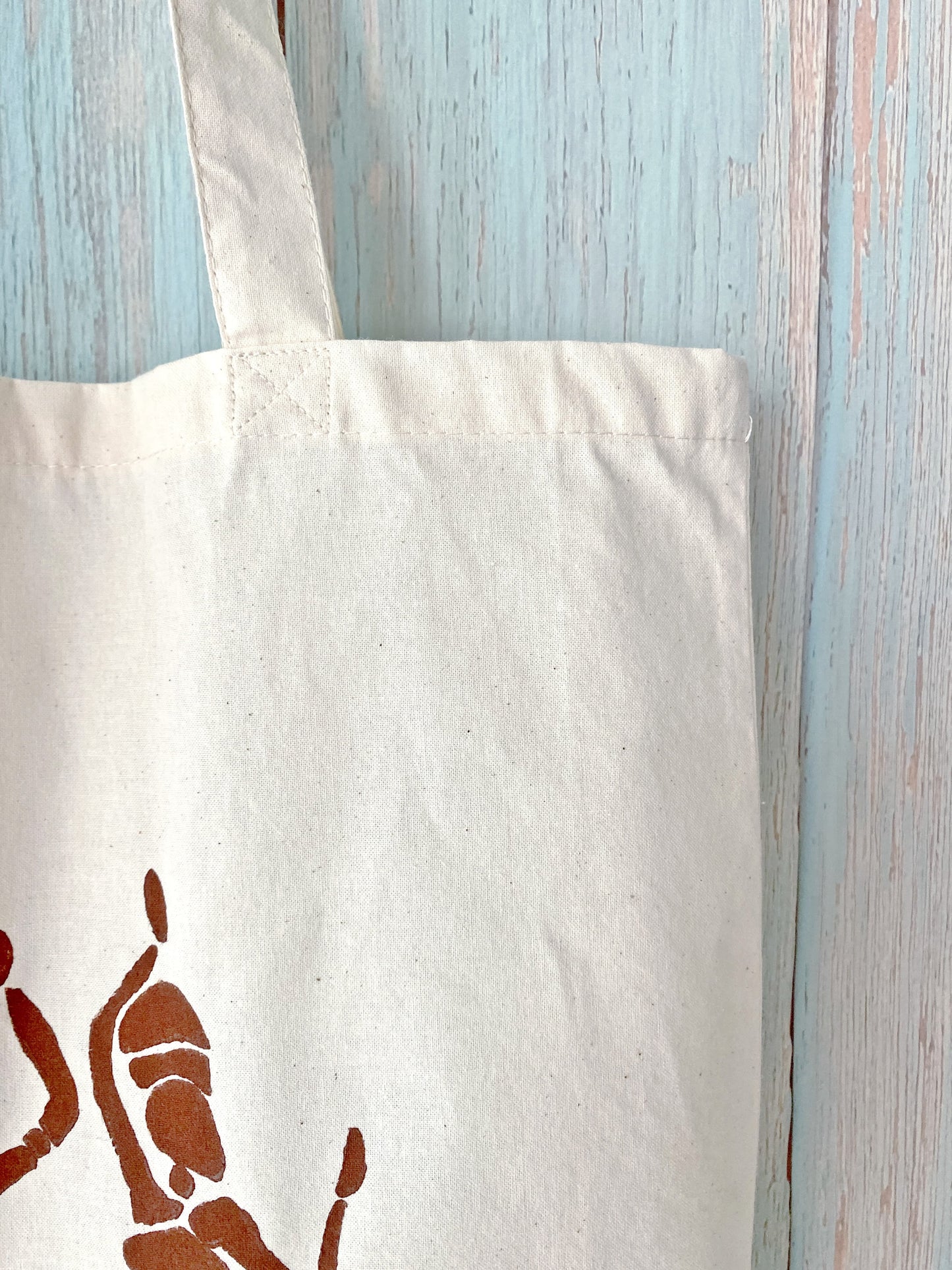 Wrapping this hand-printed canvas tote as a birthday gift for mom, knowing she appreciates practical items that tell a story.