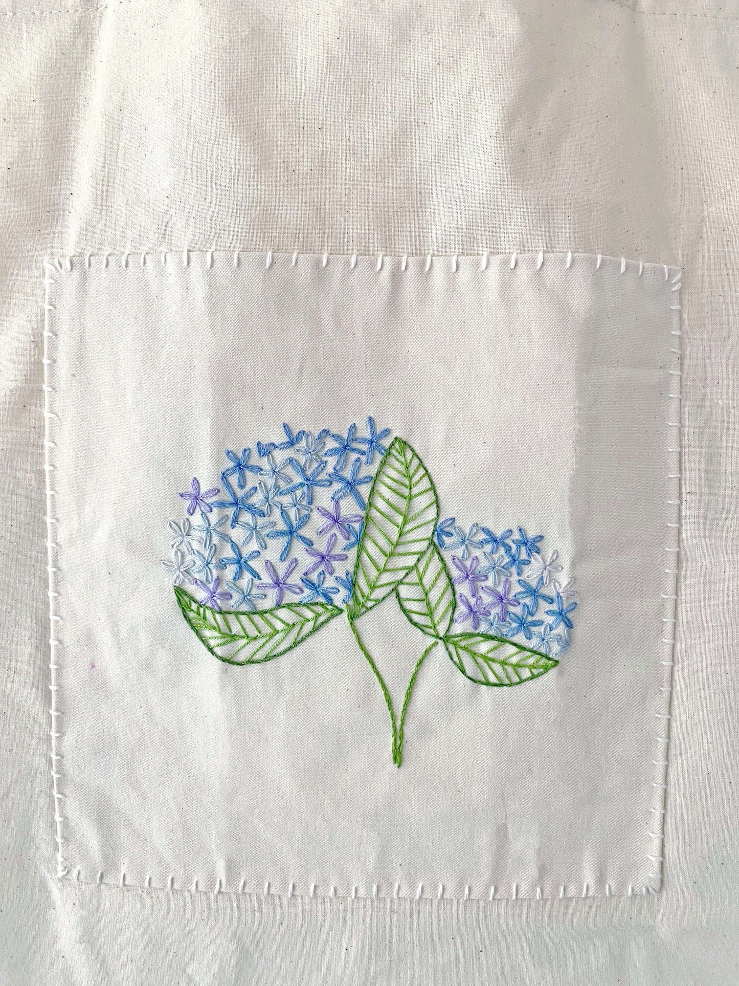 A guilt-free holiday gift for eco-warriors, combining natural sustainable materials with the human touch of delicate hand embroidery.