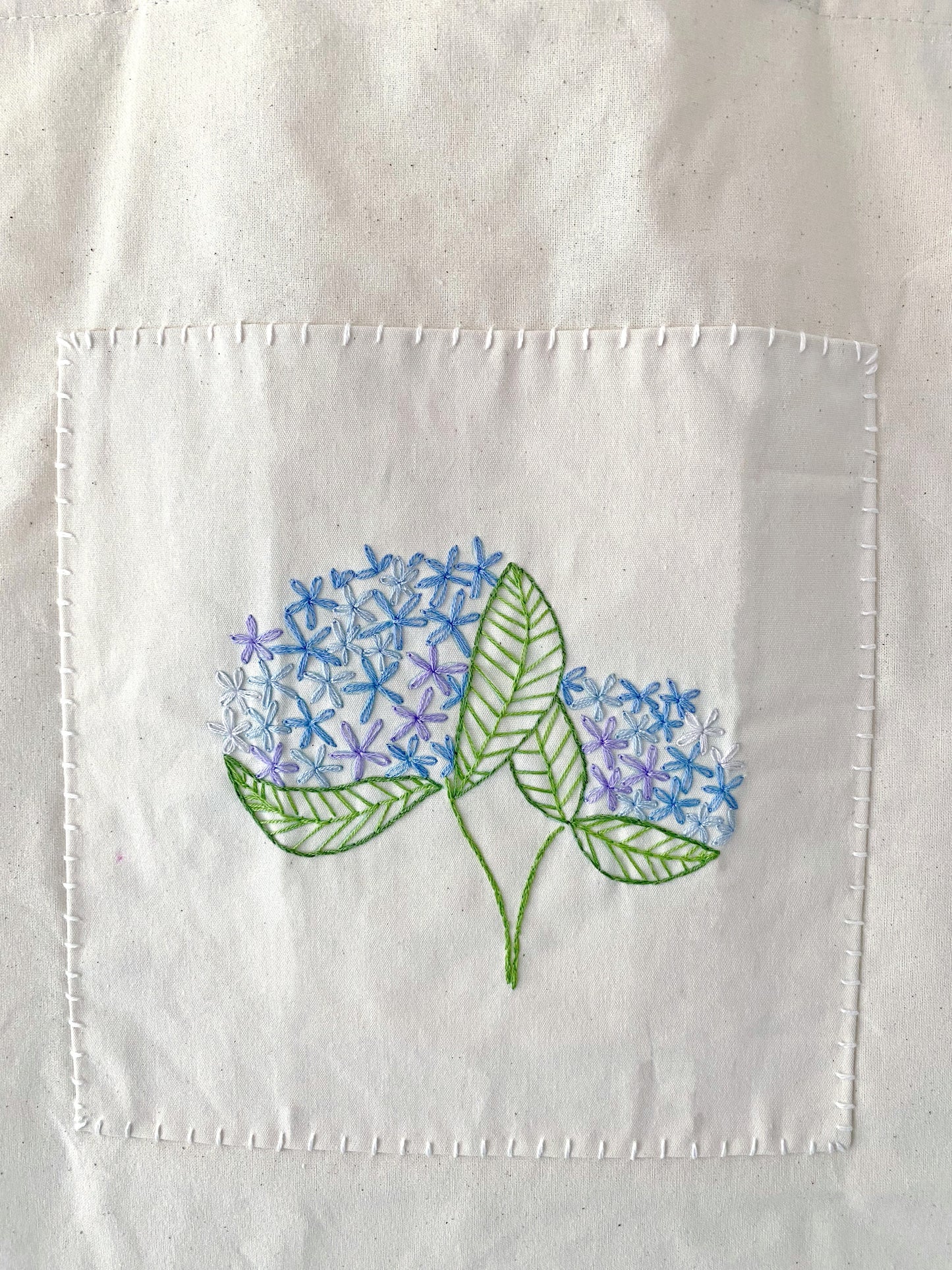 A guilt-free holiday gift for eco-warriors, combining natural sustainable materials with the human touch of delicate hand embroidery.