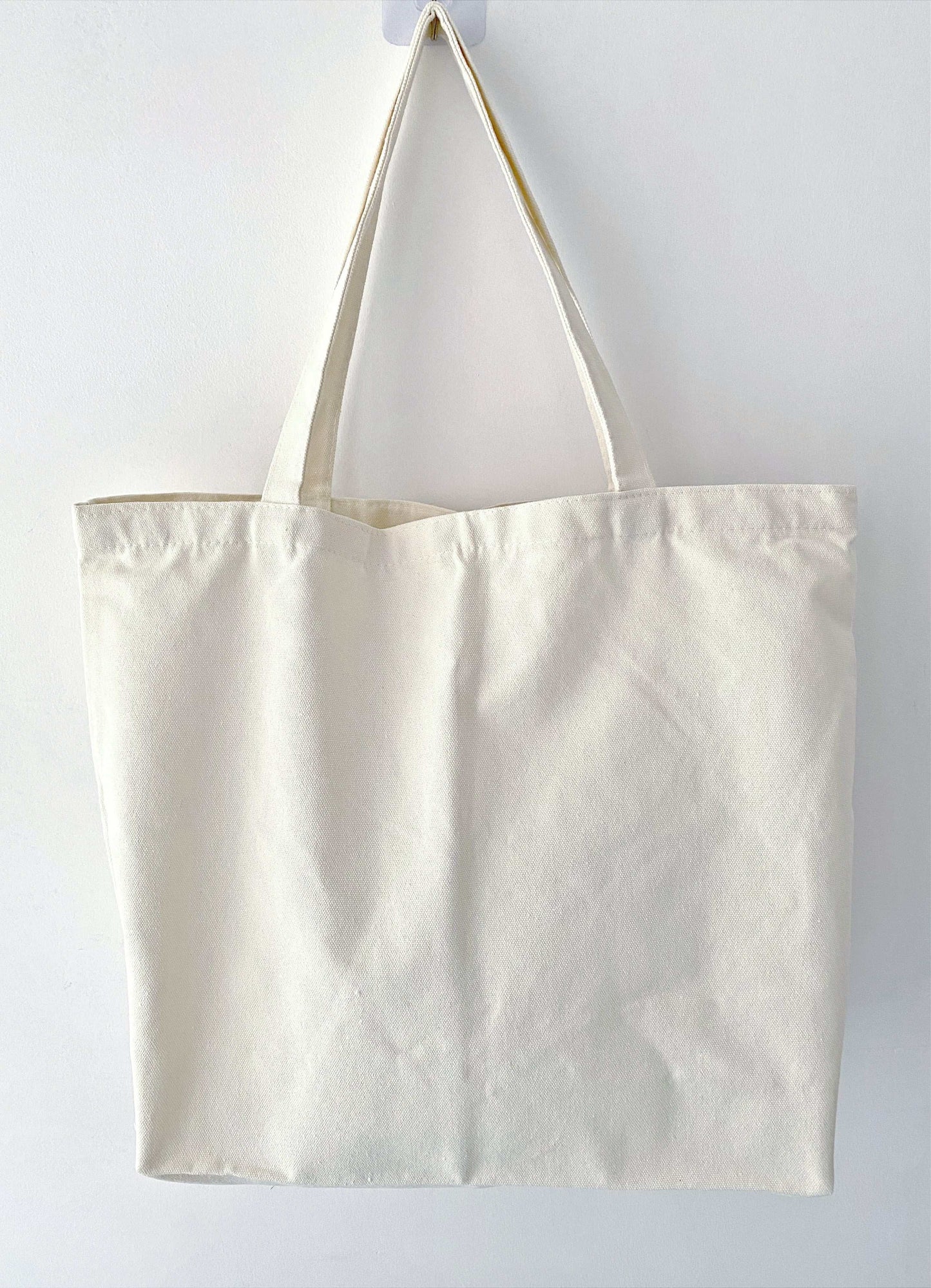 Oversized canvas tote organizing chaos effectively, holding kids' toys and snacks while still looking chic enough for a coffee date with friends.