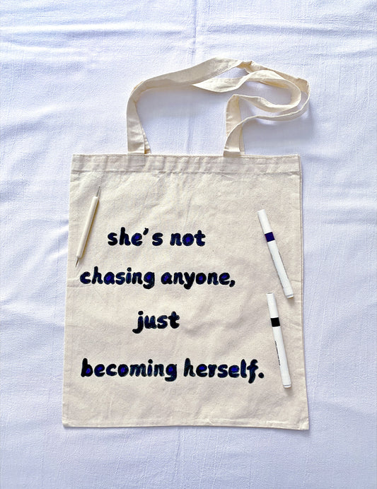 Minimal slouchy tote with handwritten text paired with everyday denim outfit