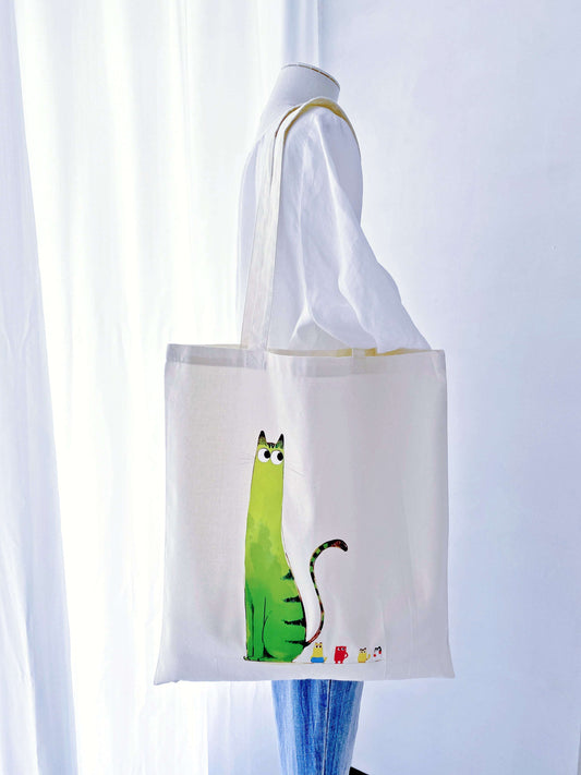 A lightweight cotton tote with a hand-printed cat, usually chosen by people who like simple things that still feel a bit special.