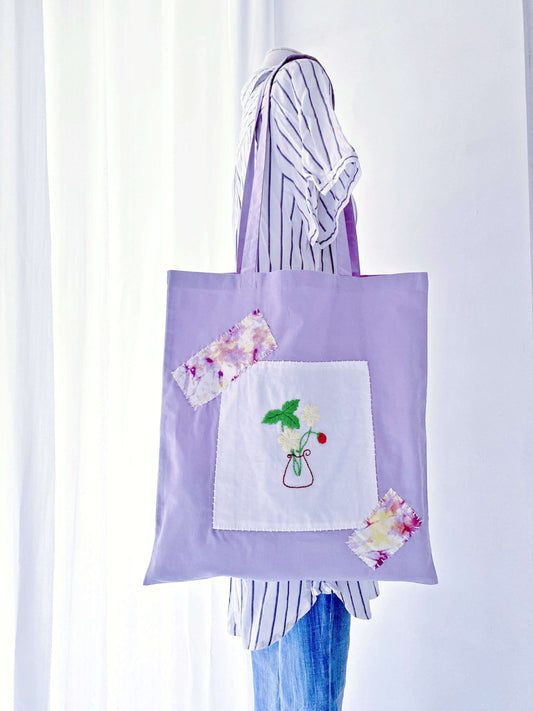 Close-up of hand-embroidered florals on ultra-soft natural cotton, a gentle breathable fabric alternative to stiff canvas.