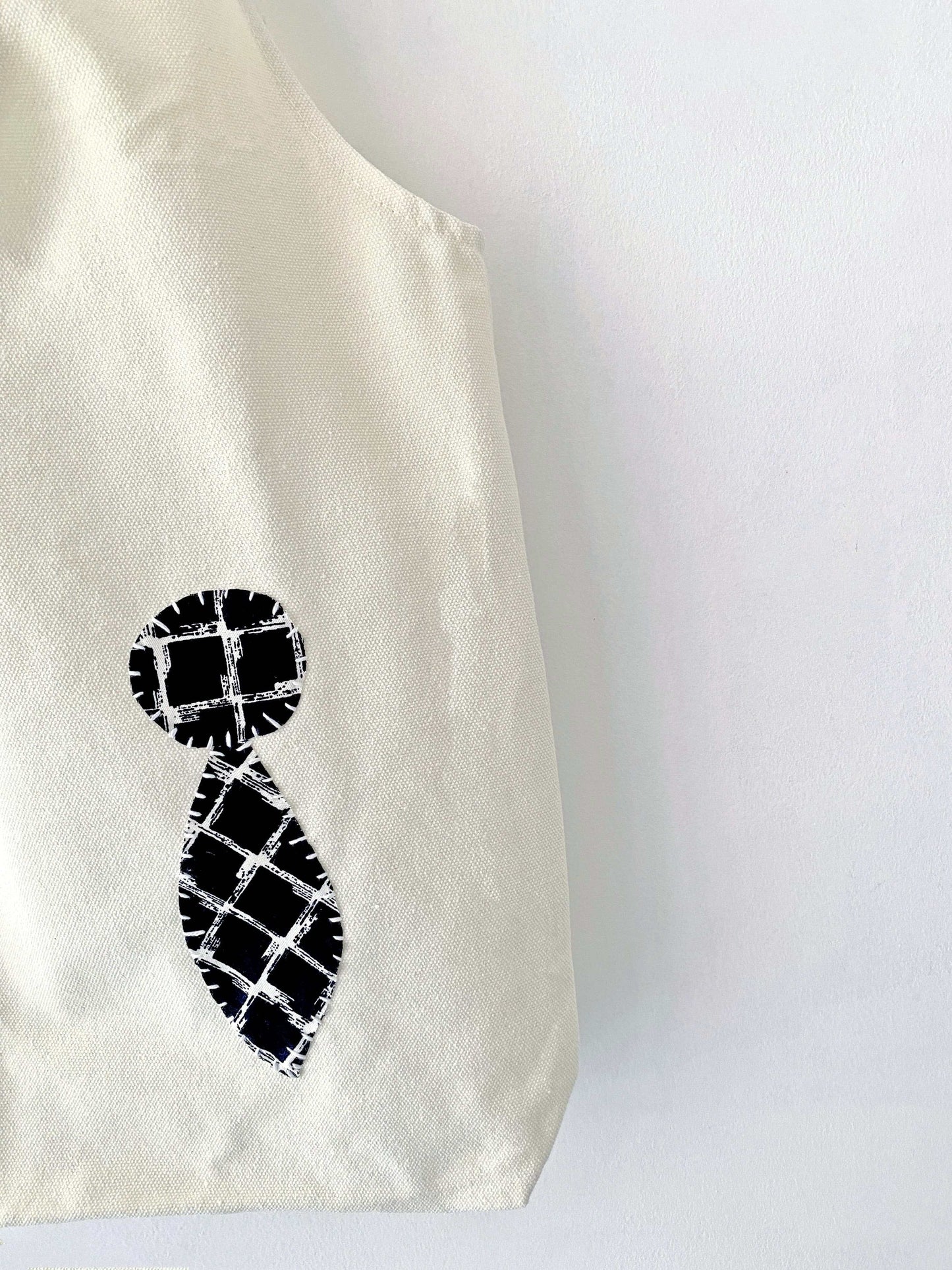 Well-loved natural fabric bag showing beautiful character and softness after months of daily use.