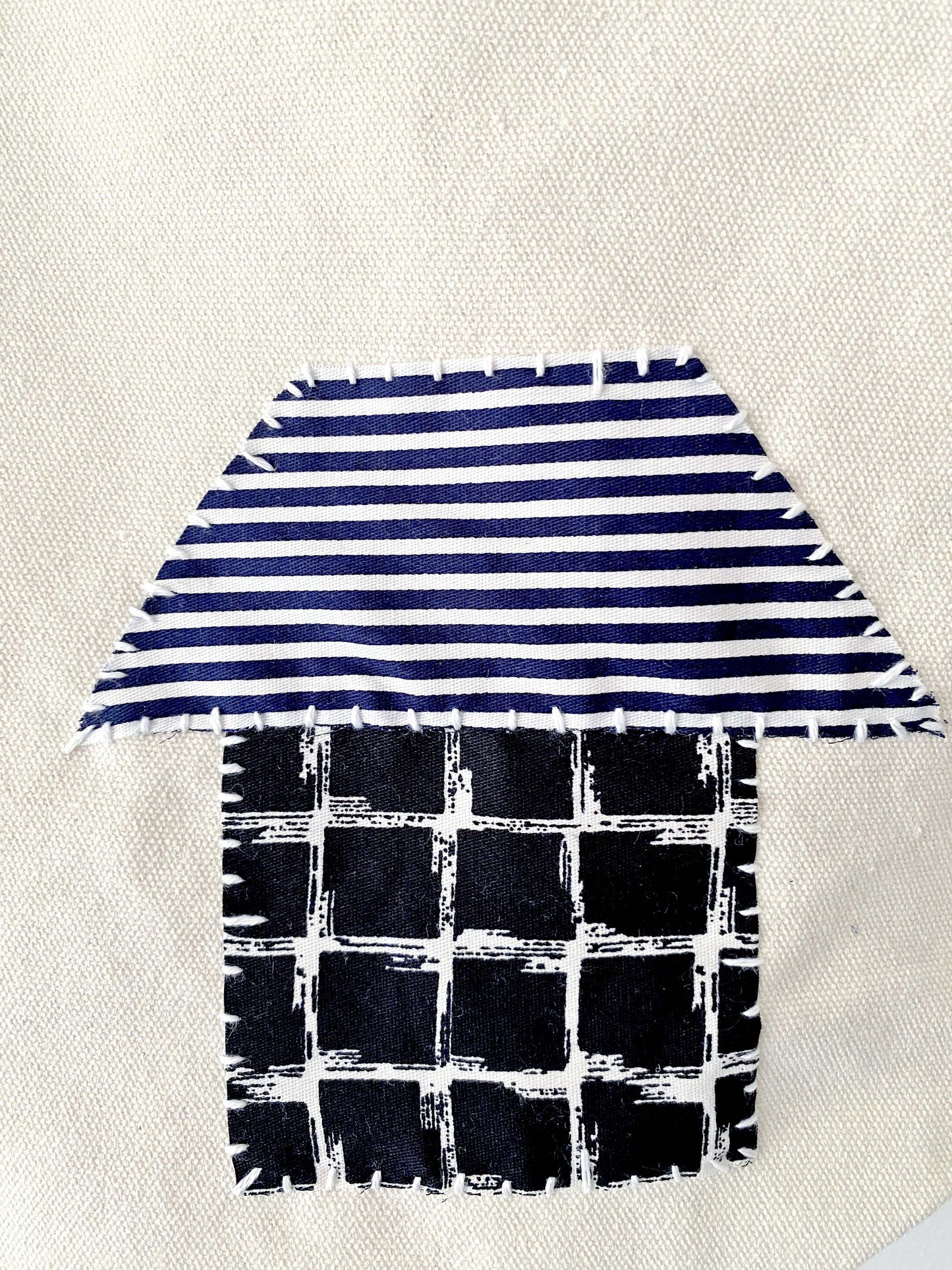 Hanging canvas tote organizing hallway clutter, blending practical storage with warm, handmade home decor.