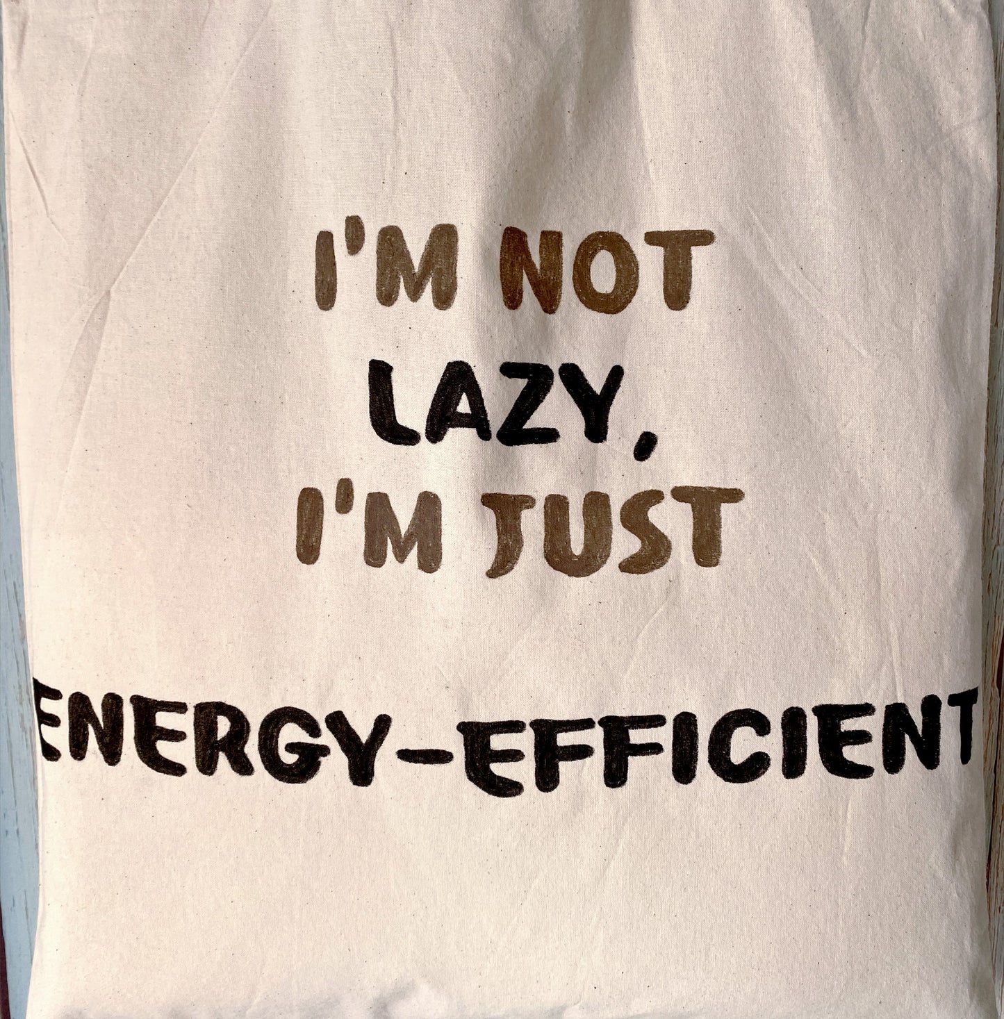 Uplifting English phrase on a tote bag that reminds users to slow down on busy days.