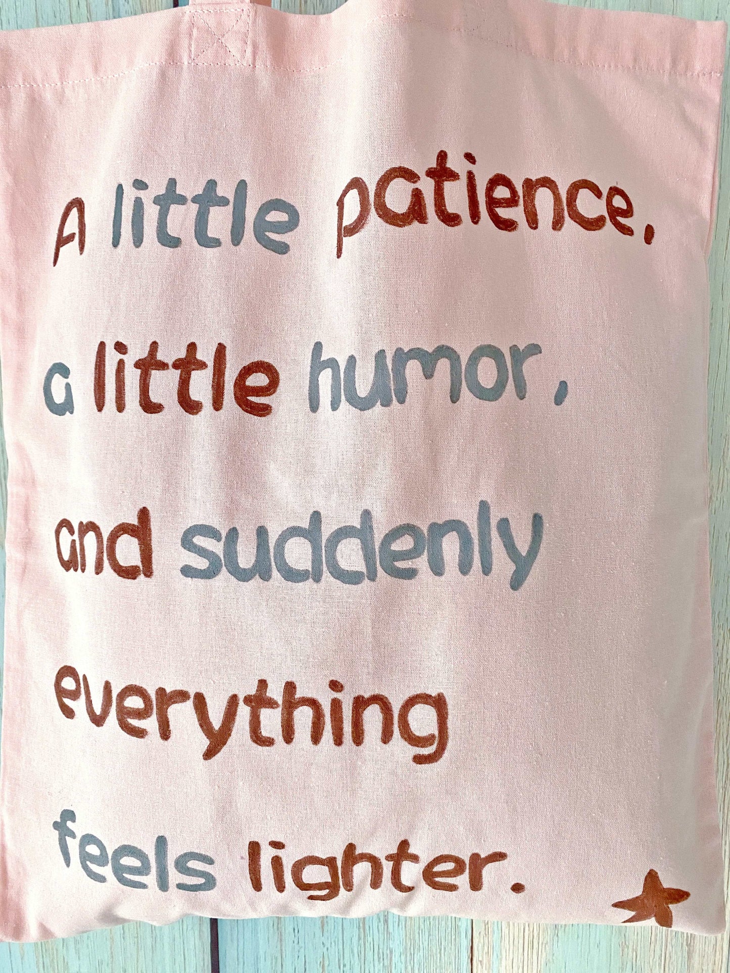 Sustainable and soft, this pink cotton tote bag with a handwritten phrase is a thoughtful choice for anyone seeking unique, eco-friendly accessories.