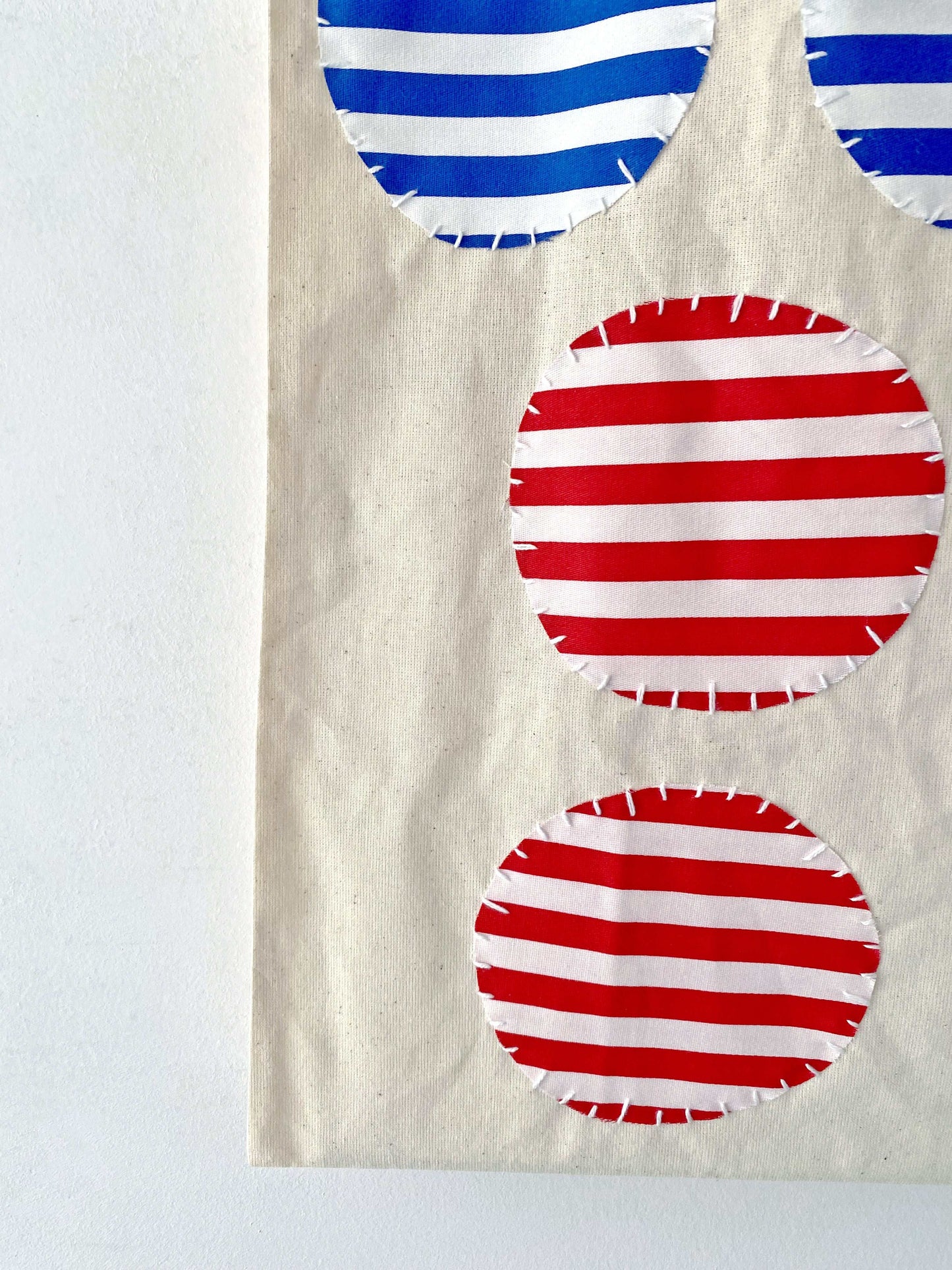 A breathable cotton tote with patchwork texture, fitting into slower weekends, bookshops, and unplanned city walks.