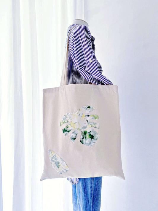 Minimalist patchwork tote crafted from eco-conscious materials, carrying groceries effortlessly on a spring morning in Copenhagen.