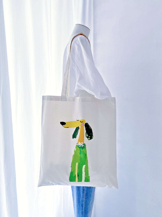 Natural wrinkles on a washed cotton tote showing the authentic character of the hand-printed puppy design