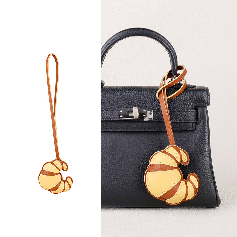 Purse accessory gift with a playful croissant-inspired shape