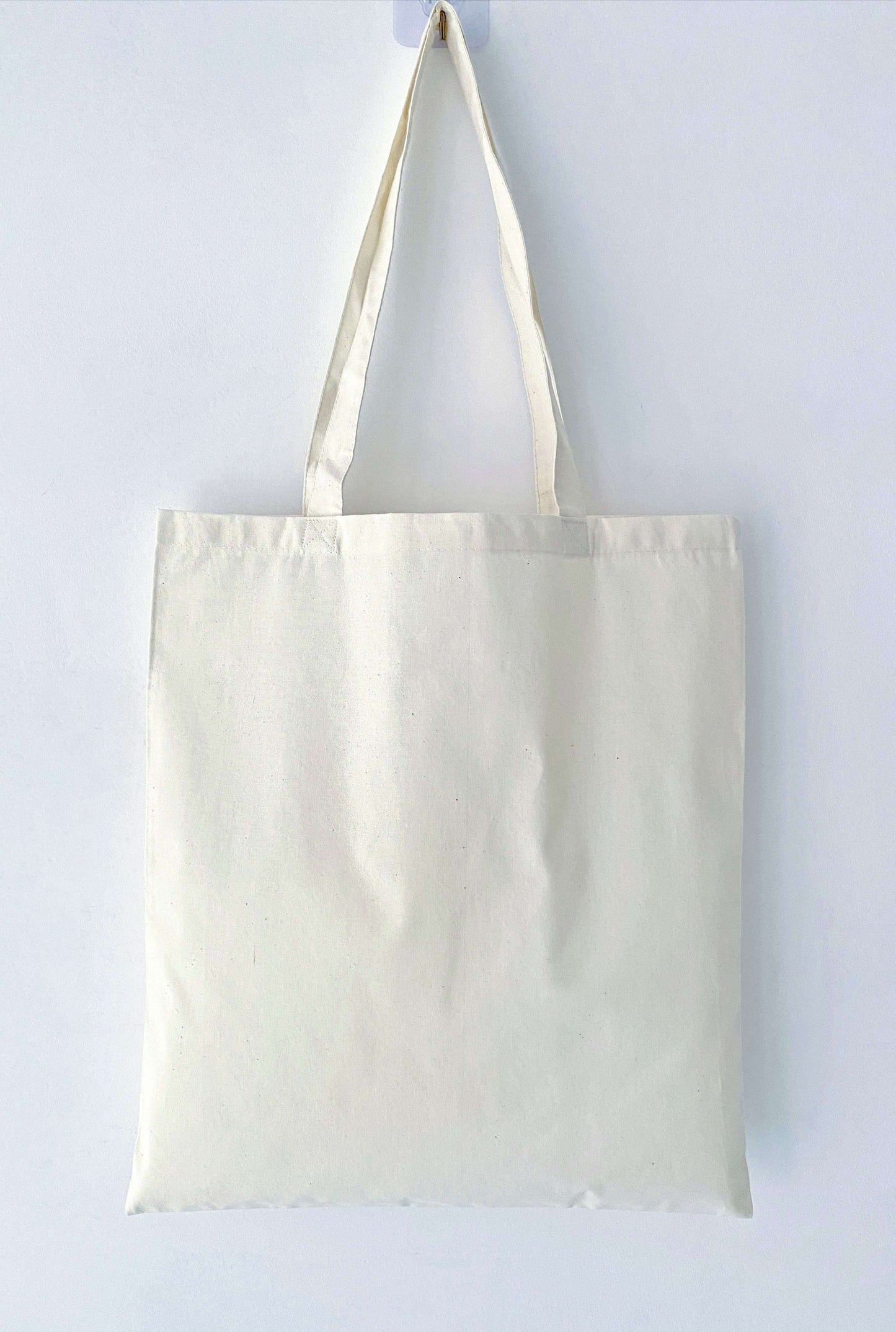 Brighten someone's day with this cheerful cotton tote bag featuring a hand-printed 'laughing girl' design, perfect for an eco-friendly gift.
