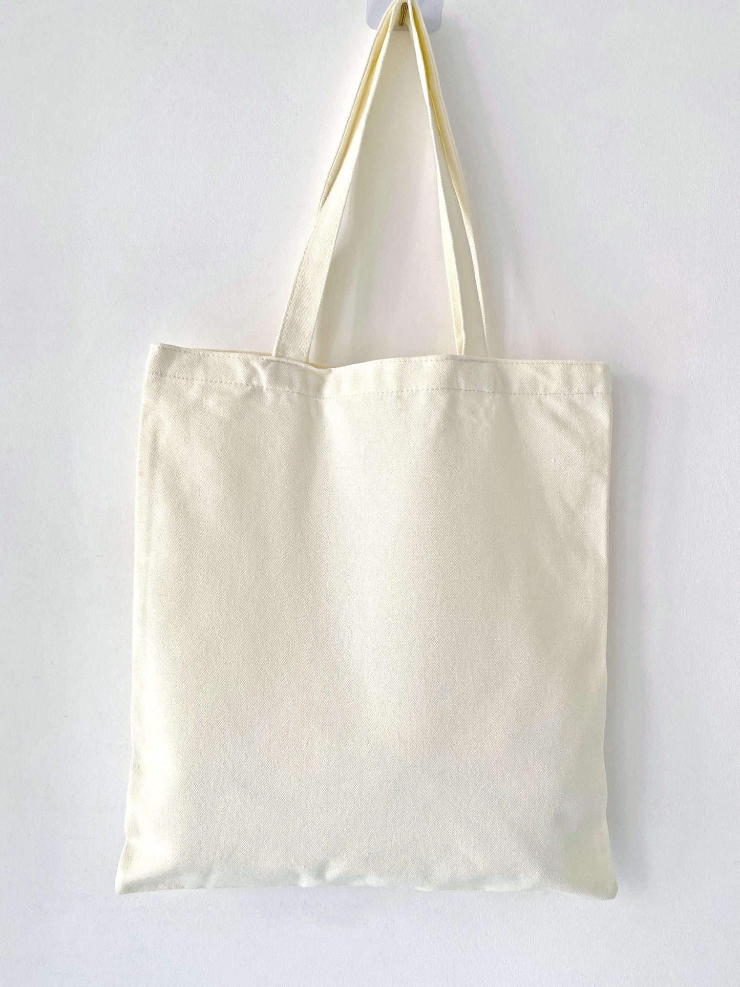 Botanical print tote bag matching a gardening outfit in the backyard