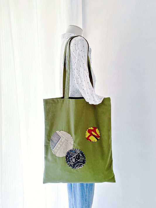 Her favorite market bag, where the olive green cotton and artistic stitching age beautifully with use.