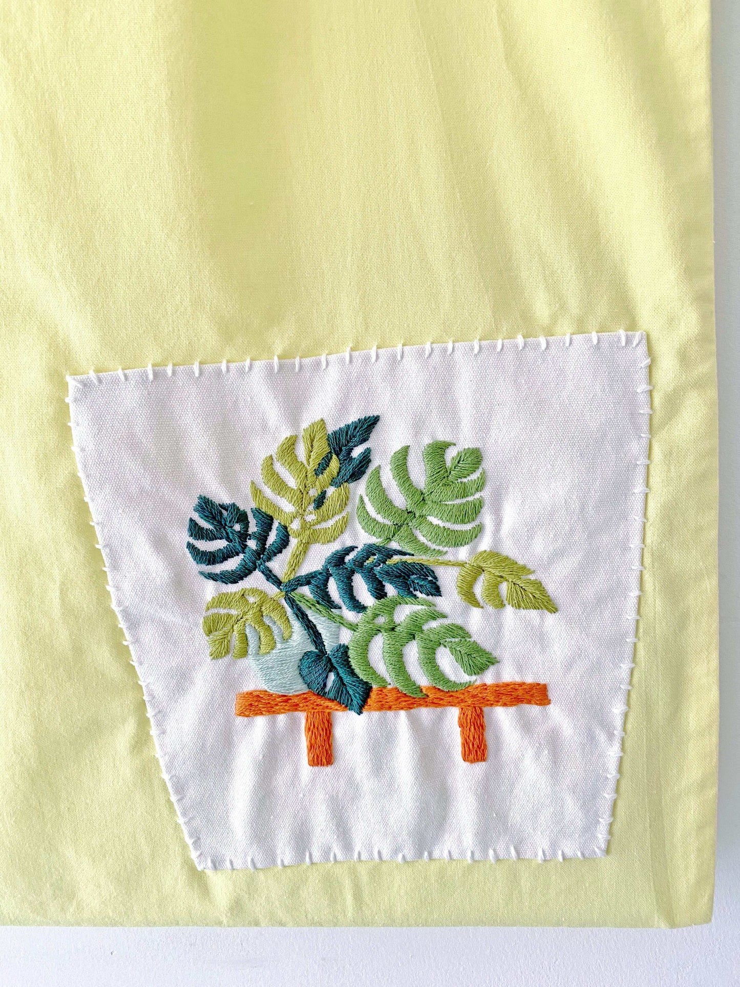 Gift a touch of nature with this hand-embroidered yellow bag, perfect for their zero-waste lifestyle.