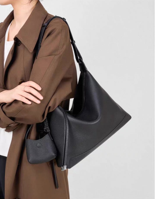Soft slouch purse styled with casual coat