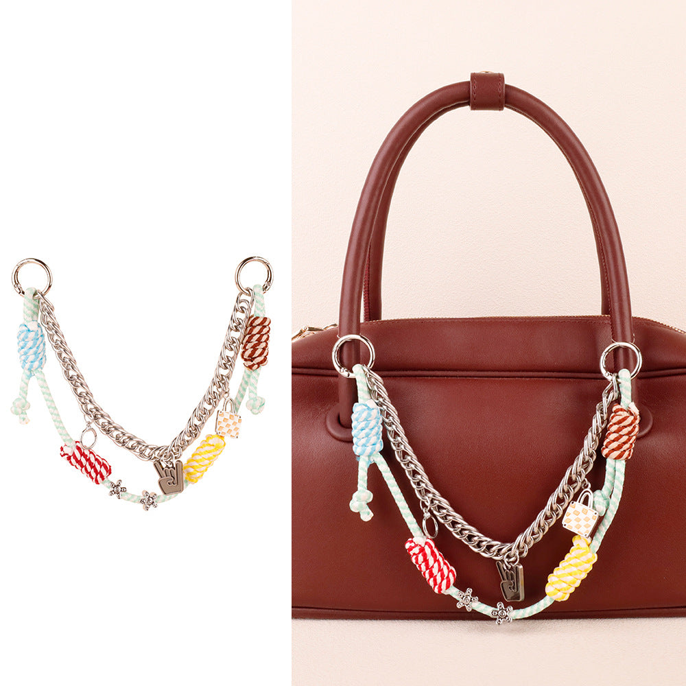 Layered dopamine cord key holder dangling from a modern bucket bag