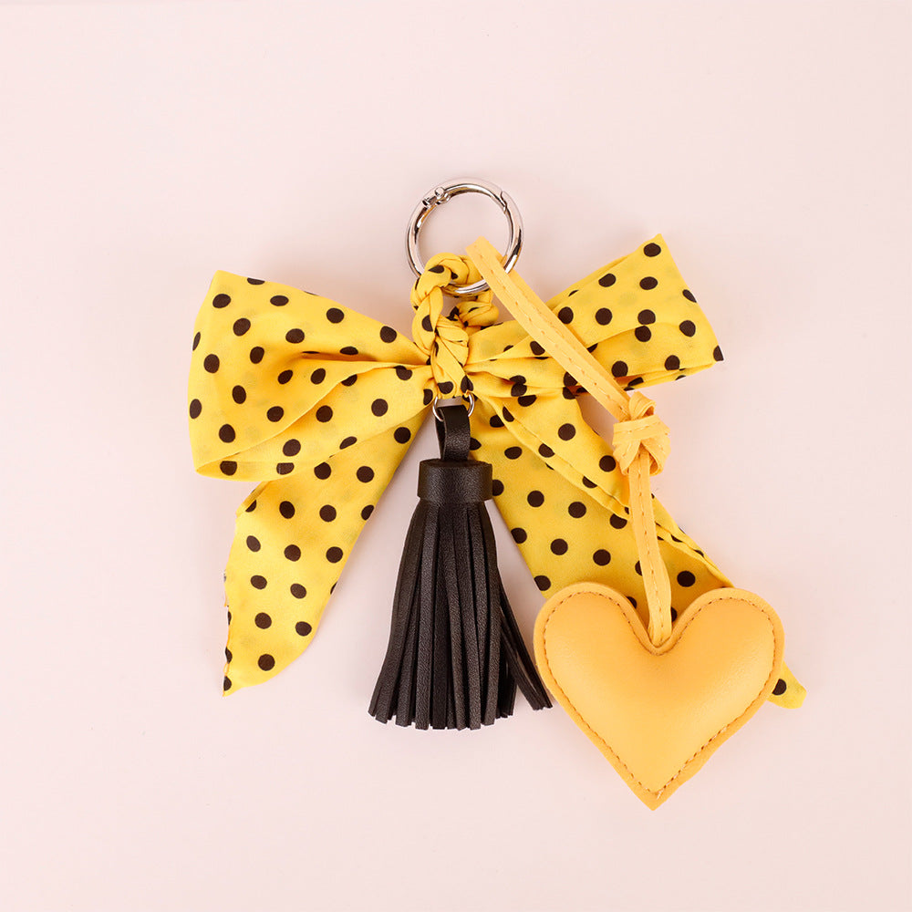 Handmade scarf bow accessory with yellow polka dots