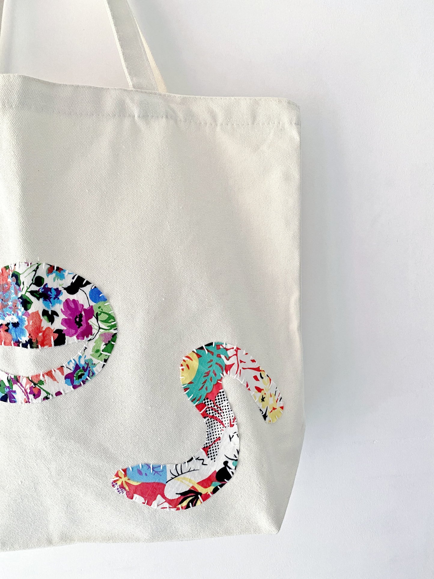 Minimalist slow fashion accessory, a hand-stitched canvas tote that elevates simple natural outfits.