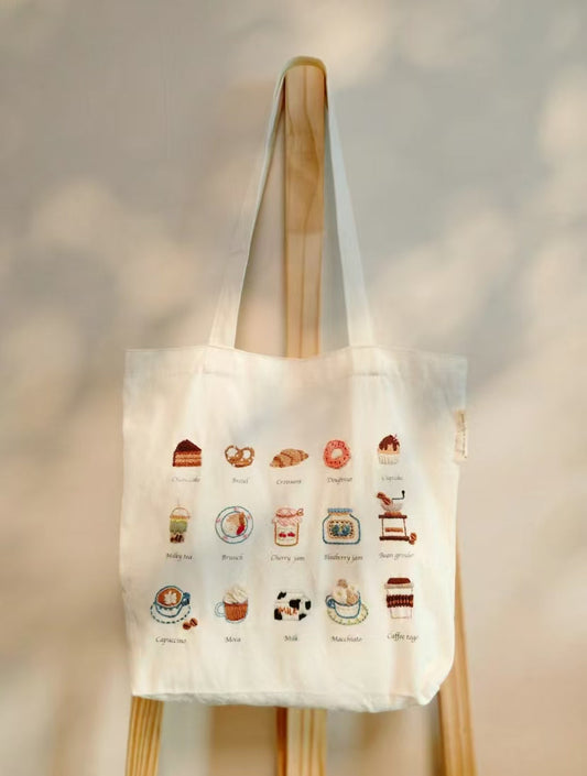 An assortment of one-of-a-kind textile bags featuring natural floral patterns and custom embroidery, showing the visual difference between artisan work and mass-produced fashion.