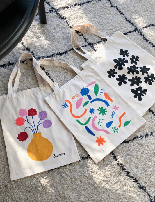 Close-up of embroidered floral tote bag on sustainable cotton canvas for daily use
