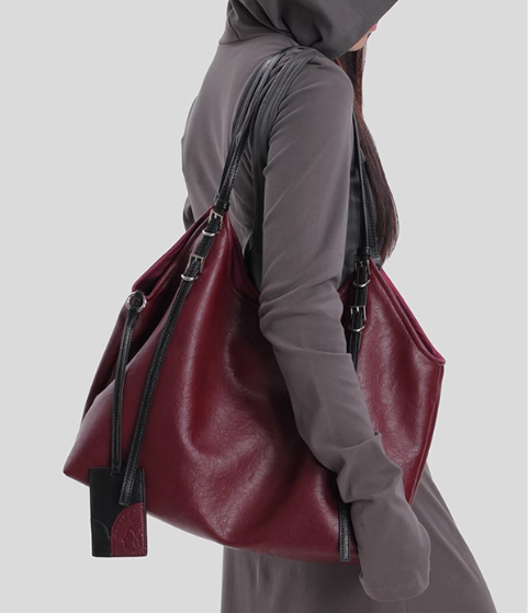 close-up of soft brown leather handbag showing natural aging texture