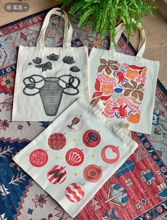 Hand-printed sustainable canvas tote bag filled with groceries at farmers’ market