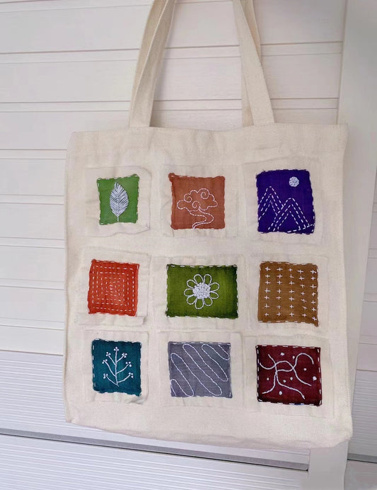 A versatile artisan canvas bag styled with a summer sundress for a casual city walk.