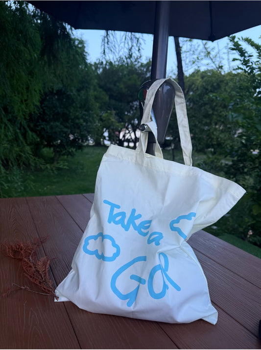 sustainable linen tote bag on a coffee shop table with books and laptop