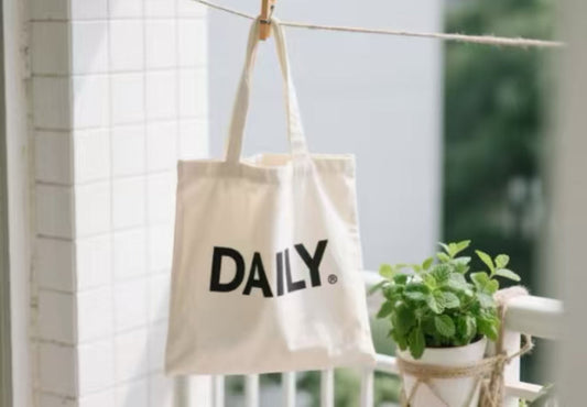 Close-up of a hand gently spot-cleaning a fabric bag with mild soap
