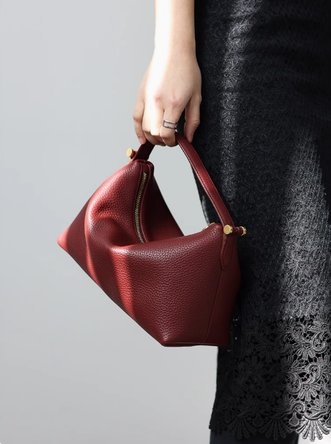 Stylish leather shoulder bag and tote bag on a shelf, ready for daily use