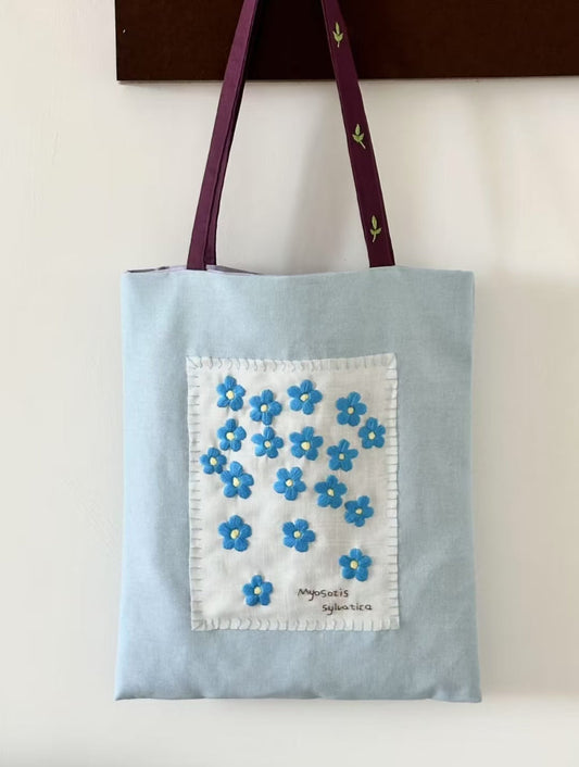 Eco-friendly embroidered cotton tote bag laid flat to dry after cleaning