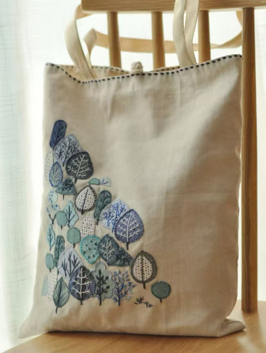 A colorful handmade patchwork fabric bag filled with books and personal items.