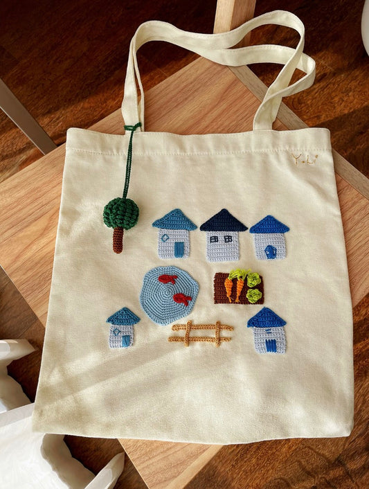 Close-up of a hand-embroidered floral design on canvas