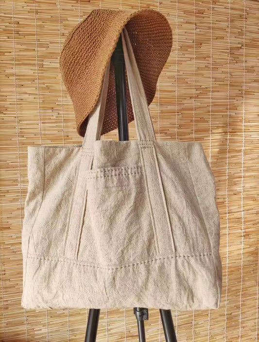 Lightweight tote bag with a hand-embroidered flower design, perfect for daily use.