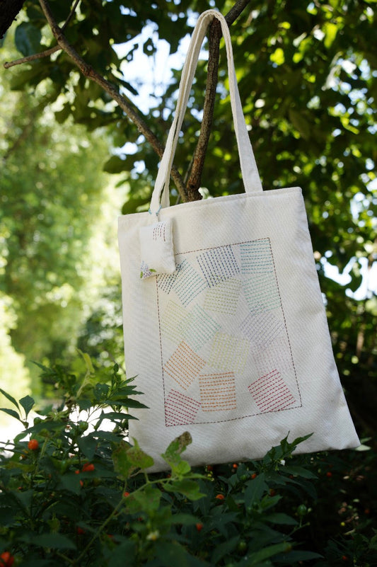 simple canvas tote bag with small hand painted detail replacing logo fashion