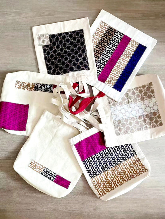 Assorted handmade quilted patchwork shoulder bags and canvas backpacks on display