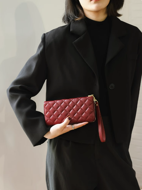 soft brown leather shoulder bag stored in a breathable dust bag
