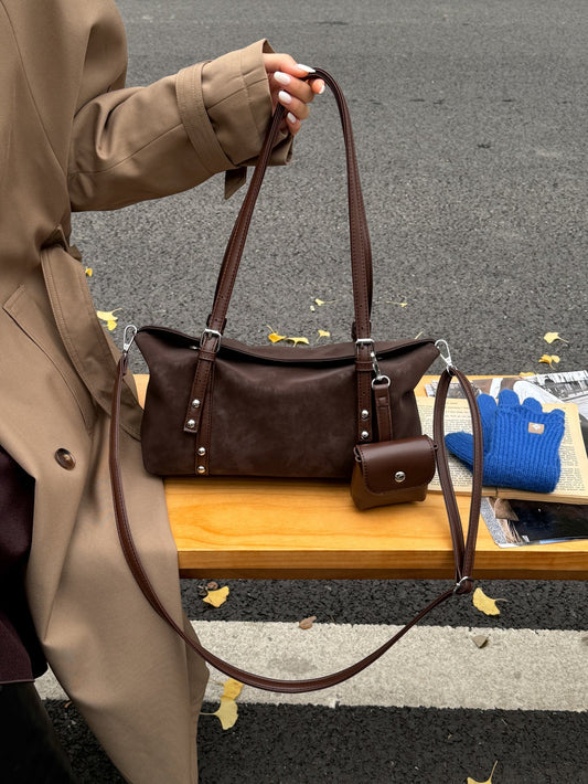 Rectangular vintage bag paired with a blazer and everyday clothing